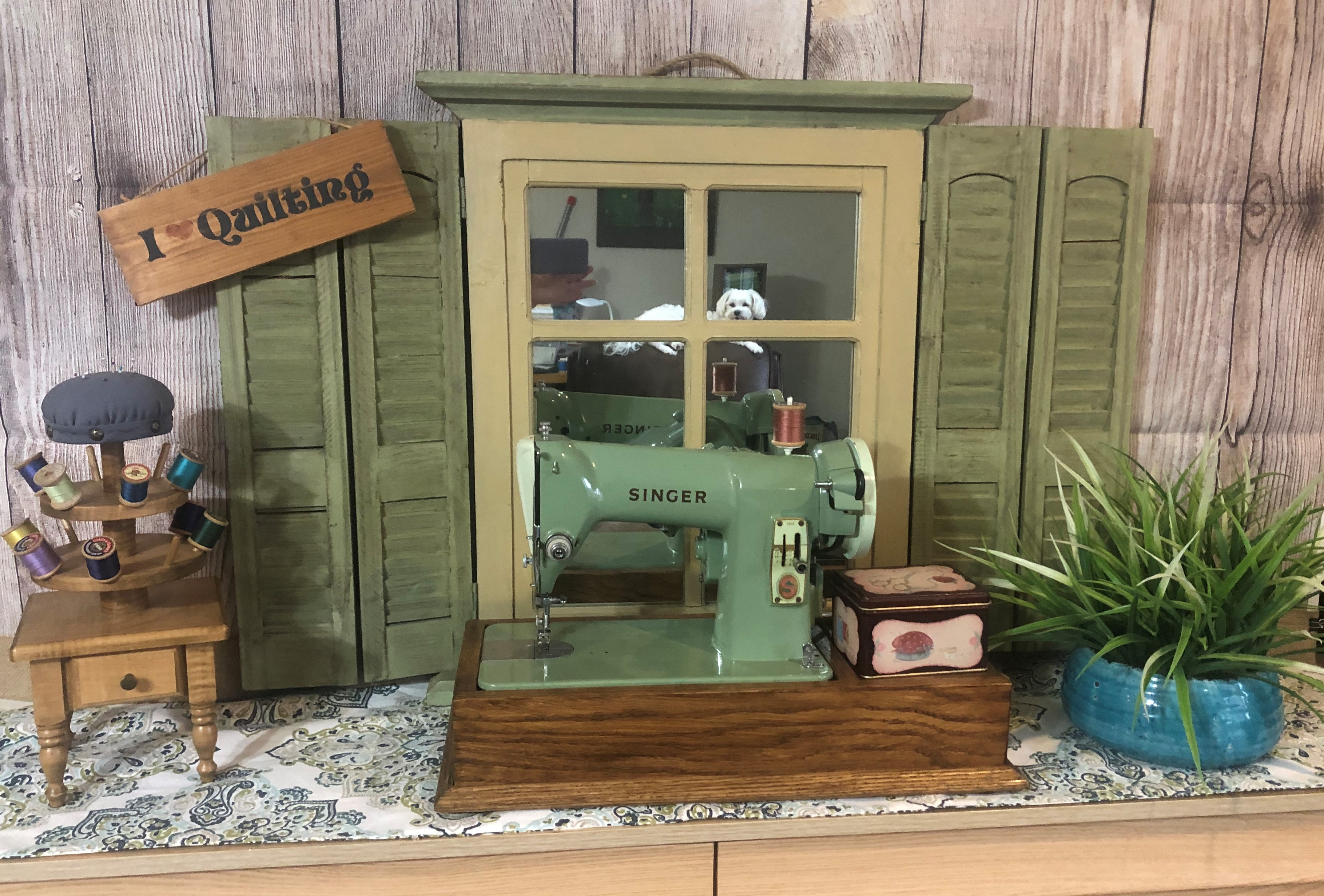 green sewing machine in front of a mirror