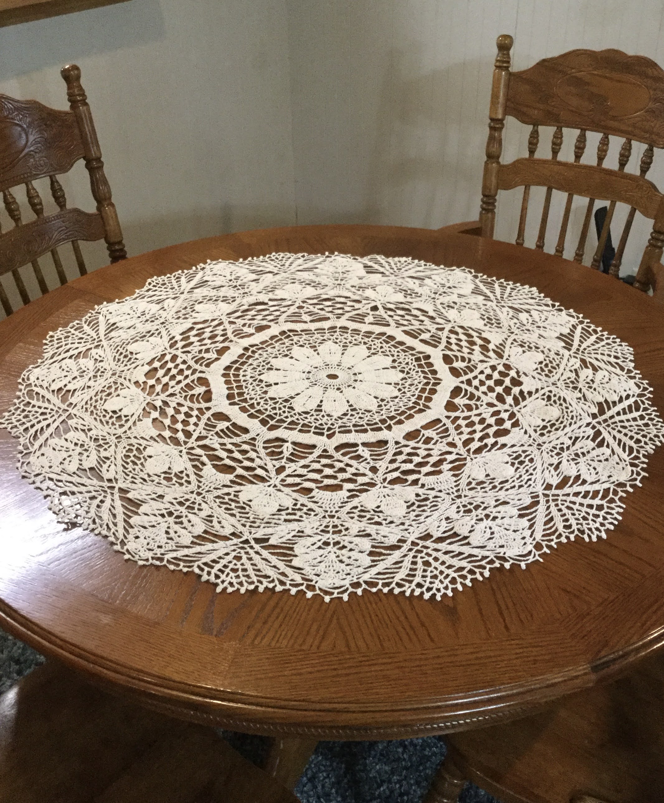 A crocheted lace doily on a table